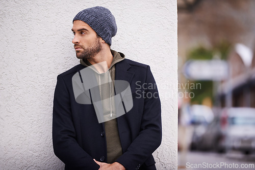 Image of Fashion, man and thinking in wall outdoor with trendy, cool and style for urban with confident. Male person, choice and planning for weekend or holiday with winter outfit and stylish in Germany