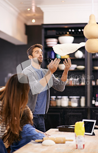 Image of Child, dough and parents throw pizza in kitchen teaching a recipe for help, support or learning in home. Playing, cooking lesson and girl baking with family, dad and mom for dinner, supper or lunch
