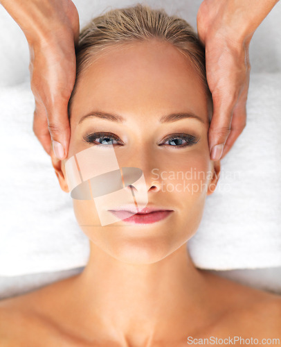 Image of Closeup, portrait or woman in massage, therapy or mental health as self care, relax or luxury zen. Retreat, girl or hand in spa, head or chakra as peace, clinic or balance on resort cosmetology bed