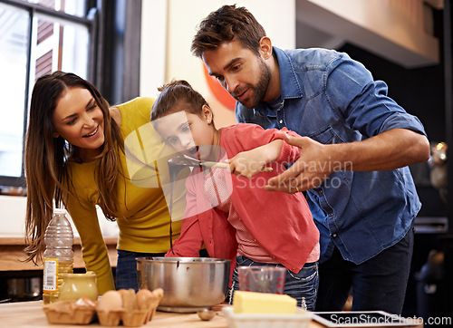 Image of Parents, girl and kitchen for baking with love, ingredients for cake or dessert with support and handmade with care. Mom, dad and kid with wow face for mixture with bonding or teaching with affection