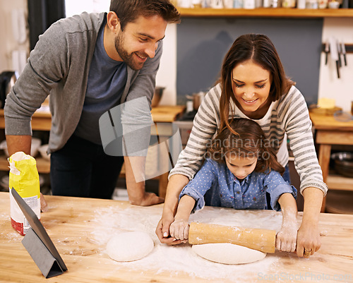 Image of Family, cooking and learning in kitchen with tablet for recipe, guide and parents with child in home. Baking, mom and dad helping girl with rolling pin and talking about pizza, dinner or meal prep