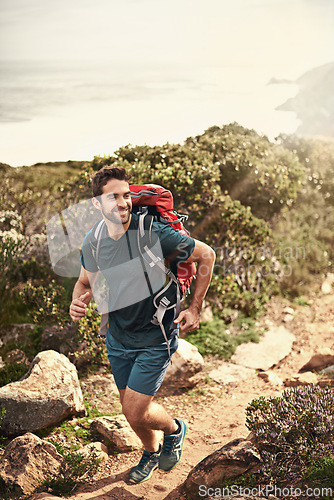Image of Man, hiking and happy for fitness, health and wellness with back and mountain. Athlete, exercise and adventure with summer, sunshine and backpack journey on cape town trail with travel and vacation