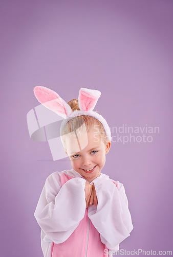 Image of Portrait, rabbit and girl with costume, happiness and Halloween outfit on a purple studio background. Face, kid and model with bunny clothes and character with smile and Easter holiday with culture