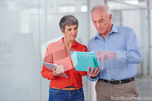 Image of Documents, team or mature business people in discussion, planning or brainstorming strategy in office mockup. Ceo, man and serious woman in collaboration with tablet for project of financial advisors