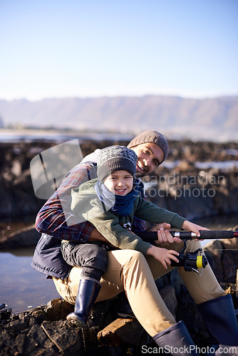 Image of Father, fishing and portrait of young boy, seaside and bonding for activity by ocean. Sea, rod and learning how to fish for childhood development, winter and hobby together while on ocean vacation