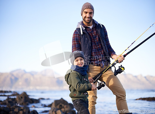 Image of Father, kid and happy for fishing at sea in winter as hobby with bonding for child development, growth and life skills in Australia. Man, boy and stand at coast for family tradition, memory and care