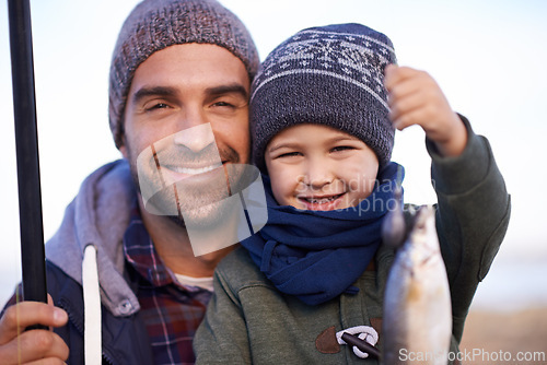 Image of Portrait, child and smile with father, fish and happiness for achievement on break. Son, water and ocean with pride, adventure and vacation on fishing trip for childhood memories and success at sea