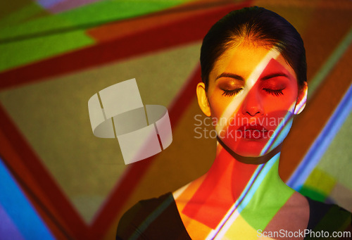 Image of Color, abstract and woman by light with art, mockup and pattern of shapes serious for creative career. Deco, female person and lady by wall and face for cosmetics, beauty and skin care or treatment