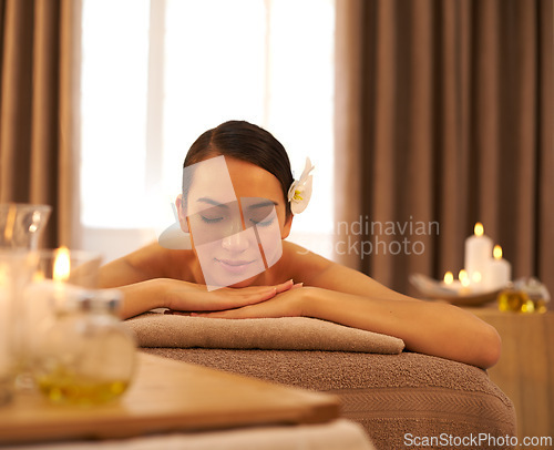 Image of Woman, candle and relax with peace at spa for aromatherapy, stress and relief and holistic massage. Female person, smile and zen at luxury resort for body health, self care and spiritual healing