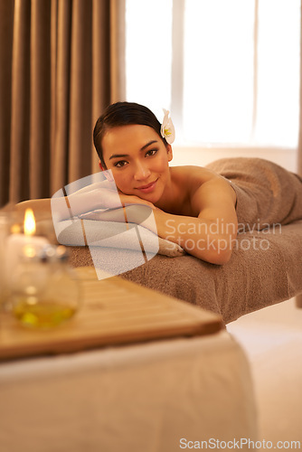 Image of Hotel, spa and portrait of woman with candle for aromatherapy, stress relief or body massage. Asian person, zen face and peace with smile for hospitality, holistic self care and natural wellness