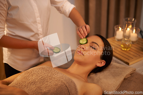 Image of Face, massage therapist and woman with cucumber in spa for peace, relax or wellness. Facial, salon or hands apply vegetable on eyes for natural beauty, skincare or healthy organic treatment with mask