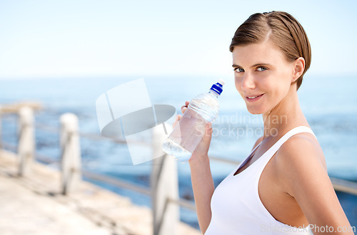 Image of Woman, water bottle and outdoor at beach for health, fresh air and fitness in nature, h2o and sea. Nutrition, detox and liquid for thirst, hydration and exercise in portrait with drink for wellness