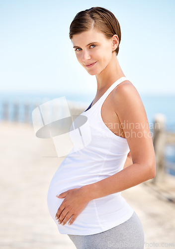 Image of Healthy, portrait and pregnant woman with fitness outdoor at beach for walk or workout in morning. Prenatal, training and care for body in pregnancy with happiness and wellness in summer at the ocean