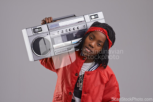 Image of Child, hip hop and portrait with radio for rap music and dance in a studio with urban clothing. Fashion, African kid and boombox with trendy clothes and youth swag with confidence and grey background