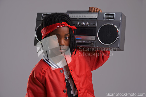 Image of Child, hip hop and portrait with radio for cool music and dance in a studio with urban clothing. Fashion, African kid and boombox with trendy clothes and rap swag with confidence and grey background