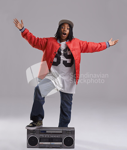 Image of Black child, excited and portrait with radio for hip hop, rap and swag dance with cool clothes in studio. Smile, teen clothing and boombox with urban style and fashion and kid with grey background