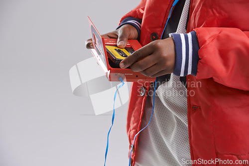 Image of Hands, music and mix tape with player for cassette, hip hop and aesthetic for youth with culture. Retro, vintage and audio from track of mini boombox for kid or child in studio with grey background