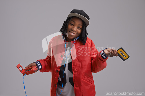 Image of Music, shrug and child on gray background with cassette for listening to song, audio and radio. Fashion, youth and young African boy with retro tech for track playlist in trendy clothes in studio