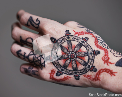 Image of Person, hands and tattoo for creative and ink for design, picture and symbol for red on closeup. Art, bold and cool for black and statement for funky, trendy and vibrant for unique, edgy and artistic