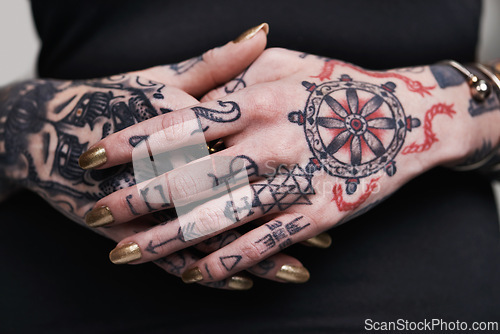 Image of Person, hands and tattoo with nails for polish, creative and ink for design, picture and symbol on closeup. Art, bold and cool for red and statement with varnish for funky, trendy and vibrant