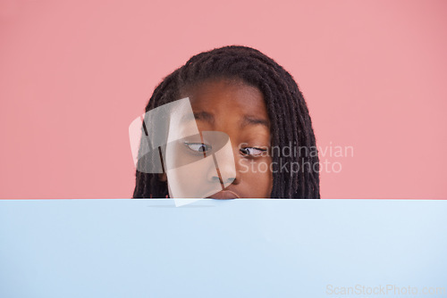 Image of Poster, funny or boy child with cross eyes on mockup in studio for announcement, offer or info on pink background. Banner, comic or teen model with billboard presentation for silly, news or promo