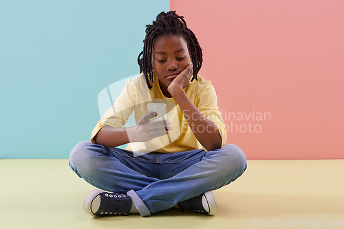 Image of Phone, search and bored boy child on a floor with social media, reading or ebook in his home. Smartphone, lazy or African teen with app for Netflix and chill sign up, google ir or watching video