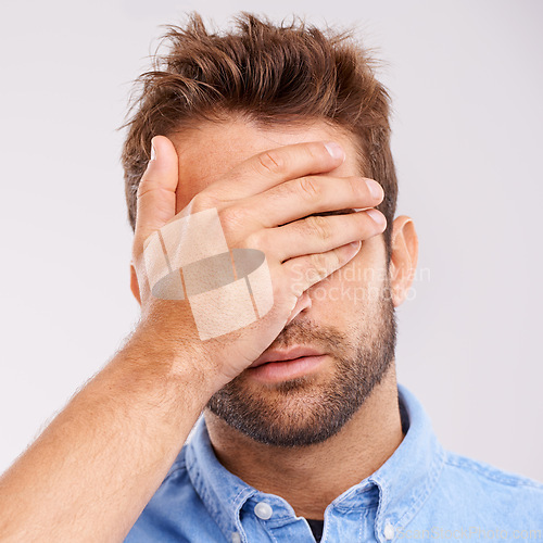 Image of Regret, stress and face of man in studio with embarrassment, thinking and headache. Brain fog, shame and tired male person with anxiety, fatigue and bad memory on white background with hand on head