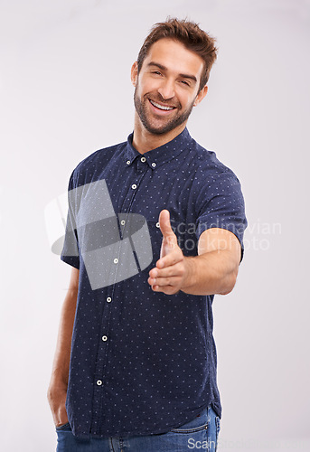 Image of Welcome, handshake and portrait of man in studio, background and introduction in mockup space. Hand, gesture and happy networking for business with confidence and hr person say hello or thank you