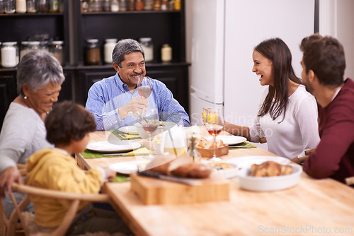 Image of Happy, big family and food with wine at dinner table in thanksgiving, bonding or get together at home. Grandparents, parents and grandchild with smile in happiness for meal, feast or weekend at house