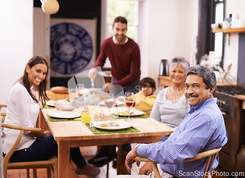 Image of Happy, portrait and big family with food at dinner table for thanksgiving, bonding or get together at home. Grandparents, parents and grandchild with smile in happiness for meal, feast or weekend