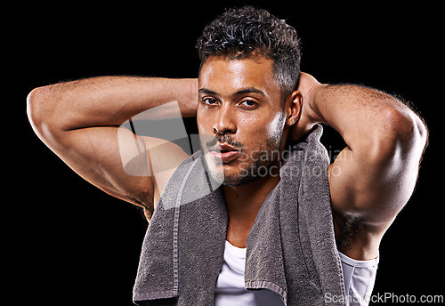 Image of Exercise, towel and portrait of man on black background for fitness, training and intense workout. Bodybuilder, sports and serious person with muscles for performance, wellness and health in studio