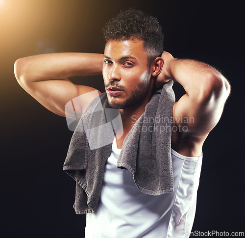 Image of Fitness, towel and portrait of man on black background for exercise, training and intense workout. Bodybuilder, sports and serious person with muscles for performance, wellness and health in studio