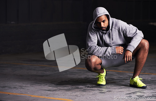 Image of Fitness, serious and man with hoodie in parking lot for exercise, training and intense workout. Bodybuilder, sports and person for strength, wellness and health with mockup space for performance