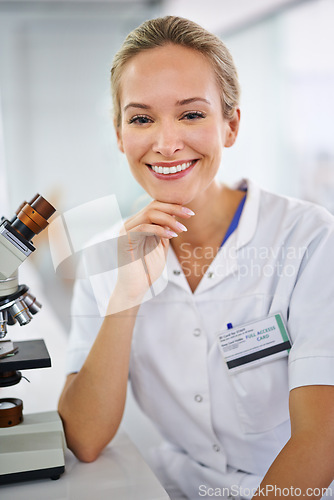 Image of Happy woman, portrait and scientist with microscope for biology, science or chemistry at clinic. Face of female person or medical professional with smile in confidence for healthcare research or exam