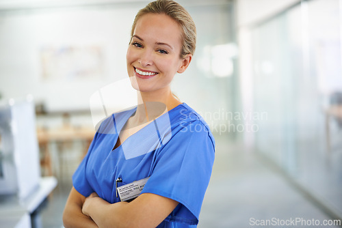 Image of Happy woman, portrait and professional nurse with confidence for healthcare or science at hospital. Young female person or medical doctor with smile and arms crossed for PHD or career ambition at lab