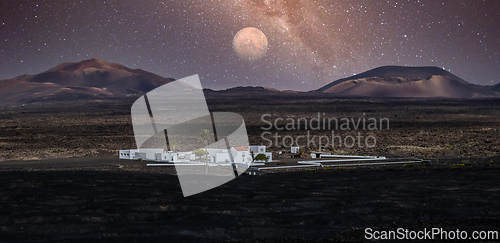 Image of Amazing nocturnal panoramic landscape of volcano craters in Timanfaya national park. Full moon over La Gueria, Lanzarote island, Canary islans, Spain. Artistic night sky picture