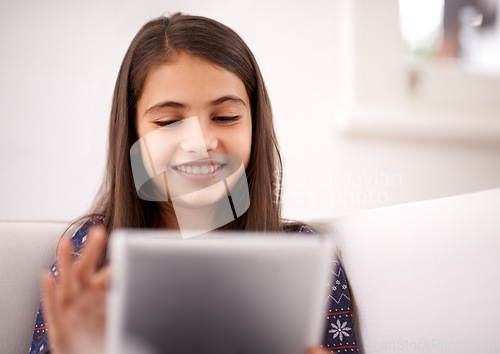 Image of Relax, couch or happy child with tablet for elearning, playing games or streaming videos on a movie website. Education, online and girl in home with technology to download on app or reading ebook