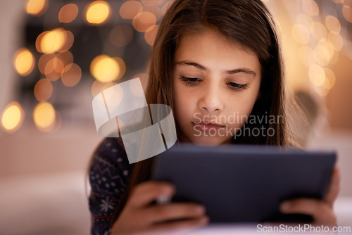 Image of Home, night or kid with tablet for streaming, playing games or watching fun videos on movie website. Girl, house or young female child with technology to download online or social media app to relax