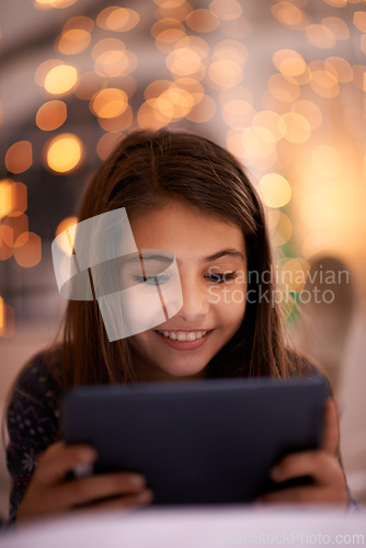 Image of Home, night or girl with tablet for movies, playing games or watching funny videos on streaming website. Happy, house or child with smile technology to download online or social media app to relax