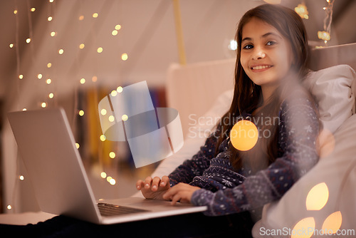 Image of Portrait, night or child with laptop for streaming, playing games and watching videos on a movie website. Smile, house or happy kid with technology to download online or social media app to relax