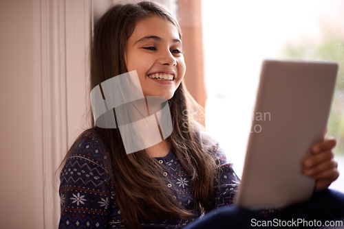 Image of Girl, kid and tablet, happy with technology and relax with ebook for reading and social media at home. Elearning, cartoon or storytelling app with internet, browsing and digital platform for gaming