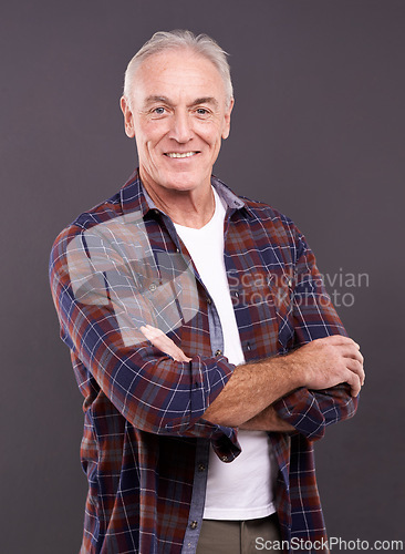 Image of Senior, fashion and man in portrait with crossed arms, confidence or modern style on grey background. Proud person, casual model and happy mature guy in studio with smile, clothes or pride in England