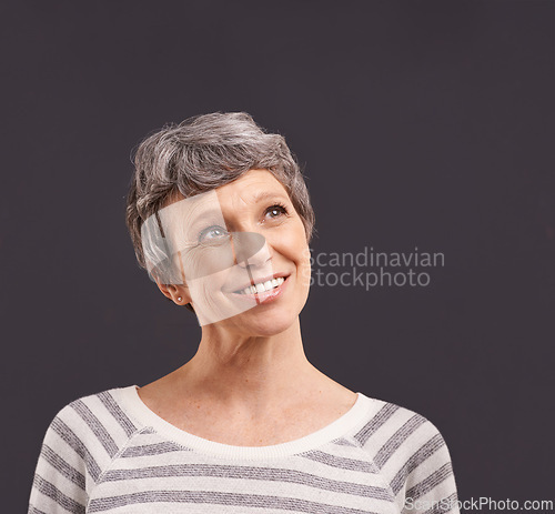 Image of Happy, thinking and senior woman in studio for faq, brainstorming or problem solving on black background. Questions, planning and old lady model curious about announcement, information or deal offer