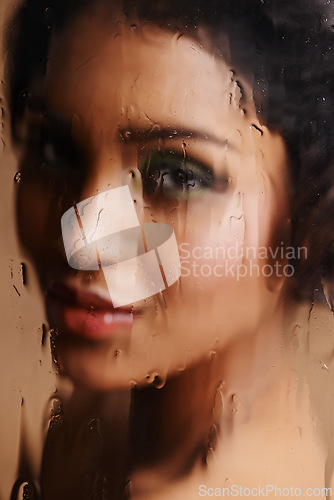 Image of Wet, beauty or woman face with glass, window or sauna for skin detox, hydration or moisture in studio. Water, makeup or female model with pure, cleanse or cosmetic toner, removal or dermatology steam