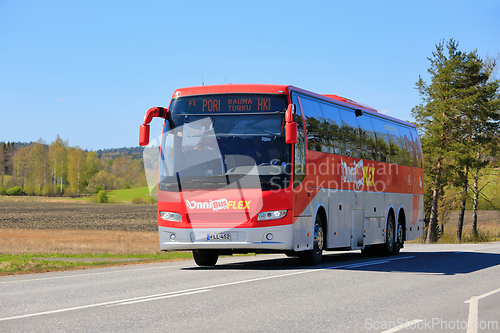 Image of Red OnniBus FLEX Coach Bus Transports Passengers