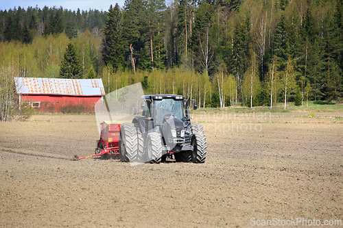 Image of Valtra Tractor and Junkkari Seeder in Field