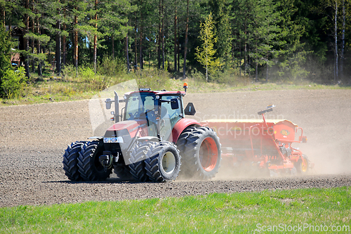 Image of Case IH Farmall Tractor and Seeder in Field 