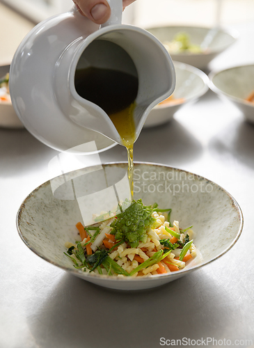 Image of Hand pouring broth