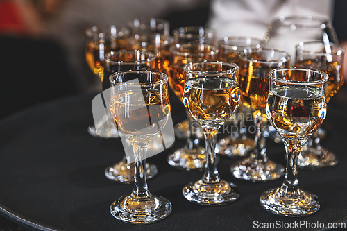 Image of Crystal glasses filled with amber-colored liquor