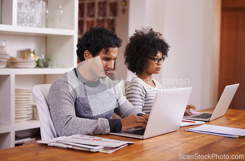 Image of Couple, laptop and remote work with house, tech and internet for career or job. Man, woman and technology with table, home office and startup for connectivity with love and relationship in apartment